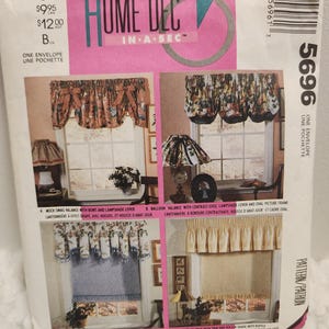 May include: A Home Dec pattern envelope featuring four window treatment designs. The designs include mock swag valances, balloon valances, scalloped valances, and skirt valances. The envelope has text that reads "Home Dec In A Sec".