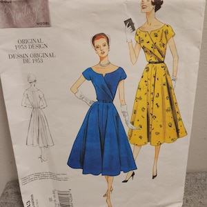 May include: A vintage Vogue sewing pattern with illustrations of two dresses. The pattern is labelled "Original 1953 Design" and includes the text "DESSIN ORIGINAL DE 1953". The dresses are a blue and a yellow floral design.
