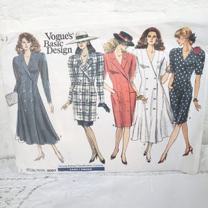 May include: A vintage Vogue's Basic Design sewing pattern with illustrations of five double-breasted dresses. The pattern includes the text "EASY" and "2007". The dresses are in various styles, including a plaid and a polka dot design.