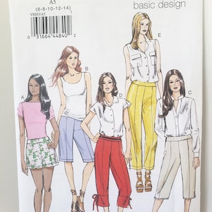 May include: A Vogue Patterns V8883 sewing pattern envelope featuring illustrations of five different outfits labeled A through E. The designs include various tops, shorts, and trousers in colors like pink, white, yellow, red, and beige.