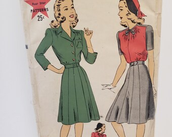 May include: Vintage sewing pattern envelope with a red star and the text "HOLLYWOOD Four Star PATTERNS 25c". The envelope features two illustrations of women wearing dresses. The text "1499" and "Size 14 32 Bust 35 H" is also visible.
