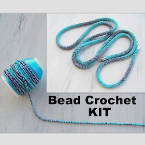 May include: A bead crochet kit with turquoise and gray beads on a spool of thread. The kit includes enough beads to make a necklace or bracelet.