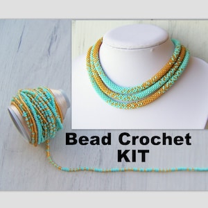 May include: A bead crochet kit featuring a turquoise and gold beaded necklace. The kit includes a spool of beads and a length of beaded chain.