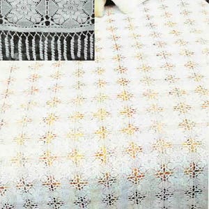 May include: A white crocheted bedspread with a repeating floral pattern. The bedspread has a detailed, openwork design with a fringe border. The intricate pattern and texture create a delicate and vintage aesthetic.