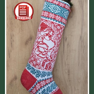 May include: A red, white, and teal Christmas stocking with a gnome design. The stocking features a knitted pattern with snowflakes and a gnome illustration. The top is decorated with pinecones and greenery. The text "CHRISTMAS STOCKING | CHRISTMAS LITTLE GNOME PDF KNITTING PATTERN # A6" is at the top.