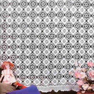 May include: A white lace curtain featuring a repeating geometric pattern of interconnected circles and diamonds. The fabric has a delicate, openwork texture with a scalloped bottom edge, creating a detailed, intricate design across the entire surface.