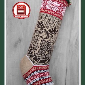 May include: A knitted Christmas stocking with a reindeer pattern. The stocking features a tan toe and cuff, with red, white, and black geometric designs. The main body has a brown reindeer design on a tan background. The top has a white snowflake design.