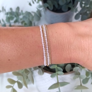 Multi-row bracelet in gold stainless steel chain and white crystal beads