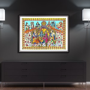 May include: A colorful framed painting depicting a group of people in traditional Indian clothing. The painting is set against a blue background with yellow and orange accents. The text "Brush & Paisley" is printed at the bottom of the painting.