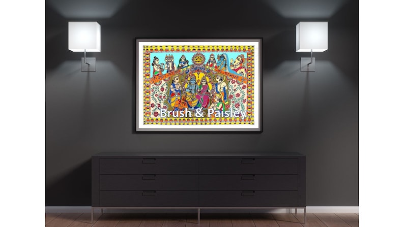 May include: A colorful framed painting depicting a group of people in traditional Indian clothing. The painting is set against a blue background with yellow and orange accents. The text "Brush & Paisley" is printed at the bottom of the painting.