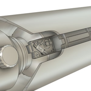May include: A cutaway view of a silver-colored telescope with a knob on the side and a small compartment with internal components visible.