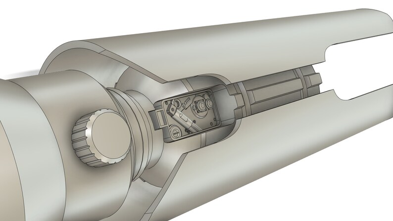 May include: A cutaway view of a silver-colored telescope with a knob on the side and a small compartment with internal components visible.