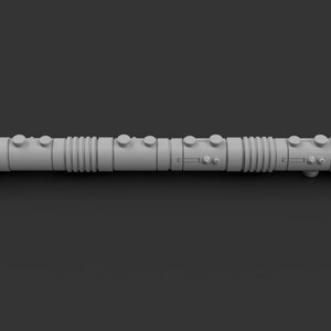 May include: A gray lightsaber with a textured surface and multiple sections. The lightsaber has a round, slightly flared end on each side.