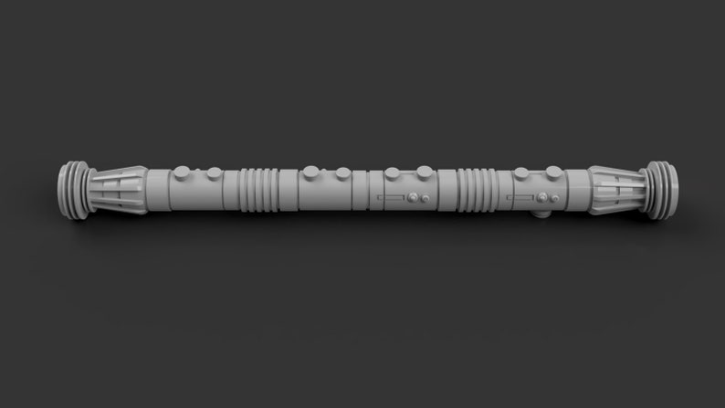 May include: A gray lightsaber with a textured surface and multiple sections. The lightsaber has a round, slightly flared end on each side.