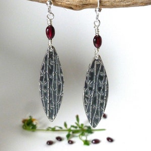 Sterling silver long dangling earrings with a bamboo texture and beautiful wire wrapped garnets...Beautiful one of a kind gift for her!