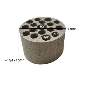 May include: A cylindrical, light gray concrete organizer with multiple holes. The organizer is approximately 2 3/8 inches tall and has a diameter of about 1 1/4 to 1 3/4 inches. The holes vary in size, with the largest being 1/2 inch.