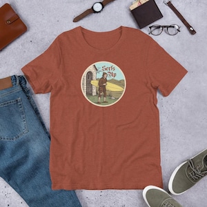 Serfs Up Shirt (V2) – Medieval Peasant with Surfboard – Illuminated Manuscript Tee – Funny History Pun – Unisex Vintage Graphic T-Shirt