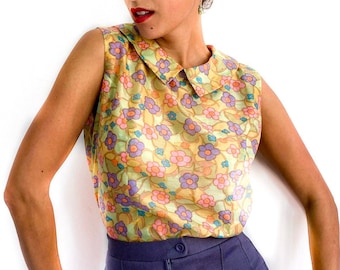 60s vintage floral print sleeveless top. Soft pastel colors in shades of green, orange, purple and blue.