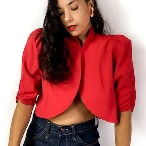 80s vintage thin red short sleeve bolero. Open at front with no buttons.