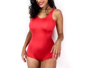 80s vintage swimsuit with a totally 1960s vibe. Bright red with thick straps. Light shine. Super sexy. Open back.
