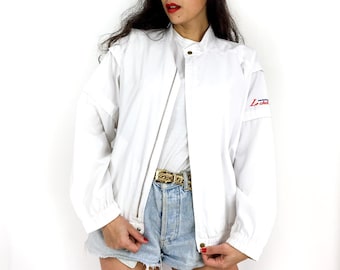 May include: White bomber jacket with a zipper closure and a logo on the sleeve that says "Le Club".