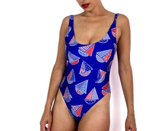 80s vintage one-piece bathing suit. Blue with little  red, white and blue sailboats. Open back. High at the legs.