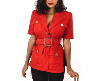 80s-early 90s red vintage short sleeve jacket. Large matching waist belt. Large gold-toned buttons and wide pockets.