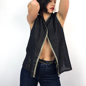 Vintage 70s black and gold vest. Thin and shimmery with very thin gold lines and gold trim along the edges. So retro. Sizes S to L.