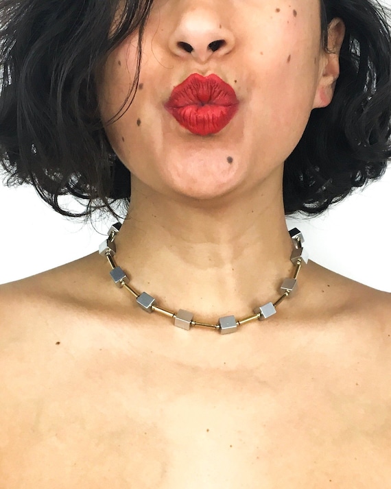 Vintage 80s necklace, little silver-toend cube beads and long gold-toned beads. Tube lock closure. Very unique!