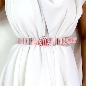 70s vintage striped waist belt. Fabric strap and buckle in shades of red, white and purple.