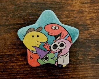 Smiling Friends Holographic Star button badge