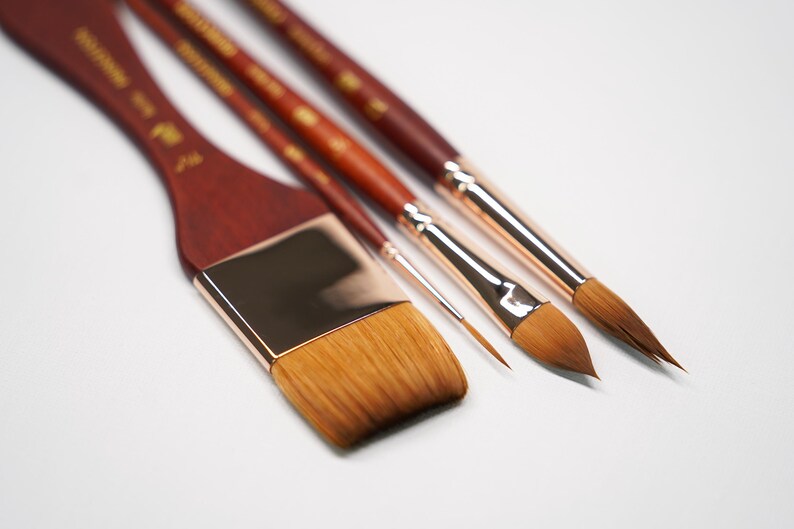 May include: Four paint brushes with wooden handles and gold metal ferrules. The brushes have different sizes and shapes of bristles.