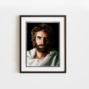 May include: A framed painting of a man with a beard and long hair, wearing a white robe. The man is looking directly at the viewer with a serious expression.