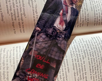 May include: A bookmark featuring a character from a popular television show. The character is standing in a forest setting, holding a sword. The bookmark has the text "You'll be coming with me" written in red.