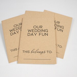 May include: Three brown paper envelopes with the text "Our Wedding Day Fun" and "This belongs to:" printed on them.