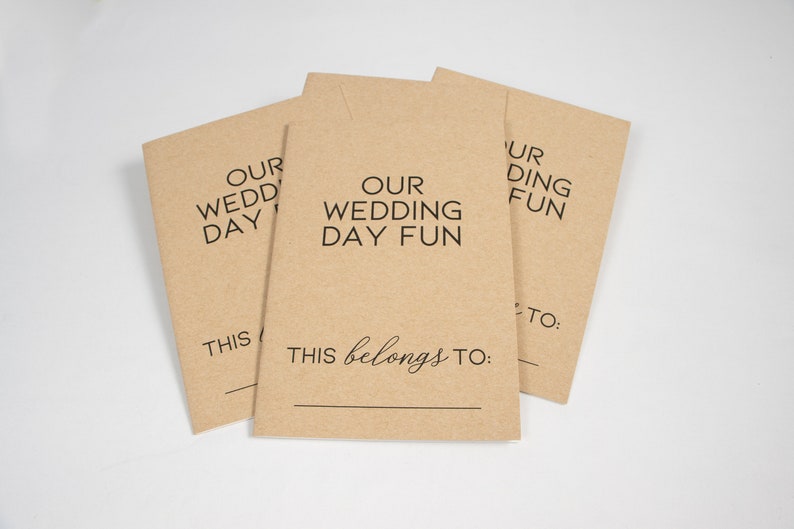 May include: Three brown paper envelopes with the text "Our Wedding Day Fun" and "This belongs to:" printed on them.