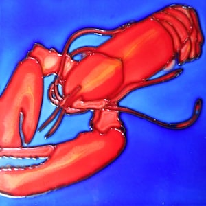 May include: A ceramic tile featuring a vibrant red lobster design against a bright blue background. The lobster is detailed with black outlines, showcasing its claws, body, and antennae. The tile has a glossy finish.