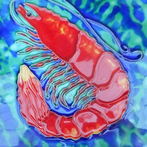 May include: A red shrimp with a blue and green background. The shrimp is painted on a ceramic tile.