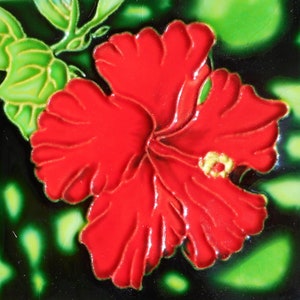 May include: Square ceramic tile featuring a vibrant red hibiscus flower with yellow center details and green leaves. The flower is set against a dark green background with lighter green accents, creating a striking contrast. This tile is suitable for home decor.