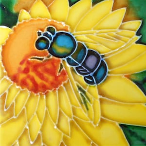 May include: A blue and purple bee with yellow and orange pollen on its legs is perched on a yellow flower with a red center.