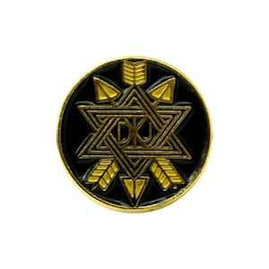 May include: Gold and black enamel pin featuring a six-pointed star with arrows and the letters "DKL" inside.
