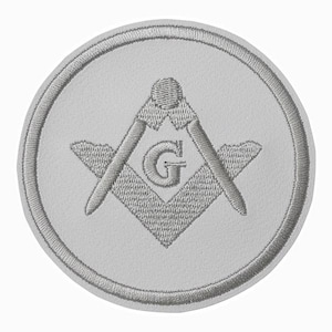 May include: A circular, embroidered patch featuring a Masonic symbol. The design includes a compass, square, and the letter "G" in the centre, all in shades of grey against a white background. The patch has a stitched border.