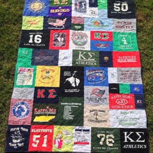 May include: A quilt made from a variety of t-shirts, featuring a variety of logos and designs, including "Kappa Sigma", "KZ Athletics", "Golden Eagles", "South Seas", "Homecoming", "Don't Mess With Texas", and "Bluetooth 51".