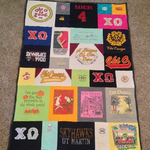 May include: A patchwork quilt made from t-shirts with various designs and text, including "Chi Omega", "Skyhawks", "Hankins 4", and "Old Hollywood Spring Formal".