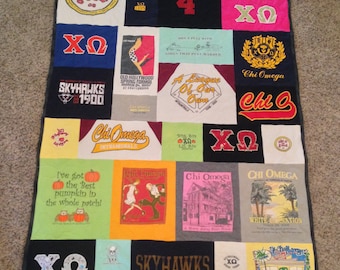 May include: A patchwork quilt made from t-shirts with various designs and text, including "Chi Omega", "Skyhawks", "Hankins 4", and "Old Hollywood Spring Formal".