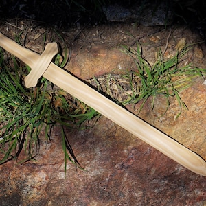 May include: A set of three ceramic mugs with a speckled, matte finish. The mugs are in shades of cream, light gray, and dark gray. Each mug has a simple, minimalist design and a rounded handle.