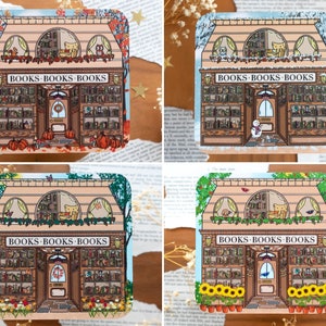 May include: Four illustrated stickers of a bookshop with different seasonal themes. The bookshop is a light peach colour with brown trim and has a sign that reads "BOOKS-BOOKS-BOOKS". The stickers feature an autumn scene with pumpkins, a winter scene with snow, a spring scene with flowers, and a summer scene with sunflowers.