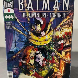 May include: Comic book cover for "Batman: The Adventures Continue" #8. The cover features Batman in a Santa hat, surrounded by a Christmas tree, with Poison Ivy and Harley Quinn. The DC Universe logo is visible.