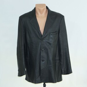 May include: A black leather blazer with a three-button closure and two front pockets.
