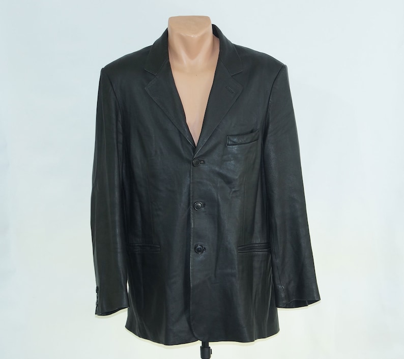 May include: A black leather blazer with a three-button closure and two front pockets.